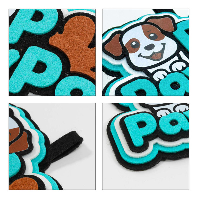 A custom felt hanging tag featuring a black, turquoise, and brown dog design on a soft felt background.
