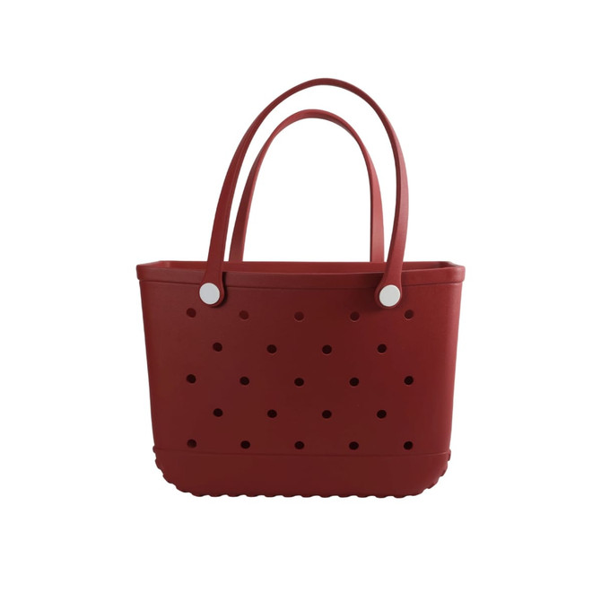 A red EVA beach bag with perforated design and two sturdy handles. It features a smooth, flexible body and rounded edges.