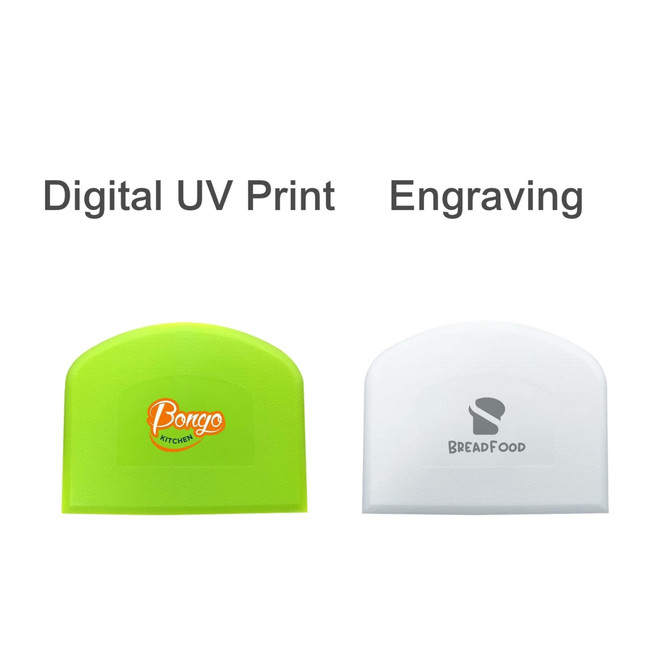A set of two bowl scrapers: one bright green with a logo and one white with a logo, both featuring curved edges.