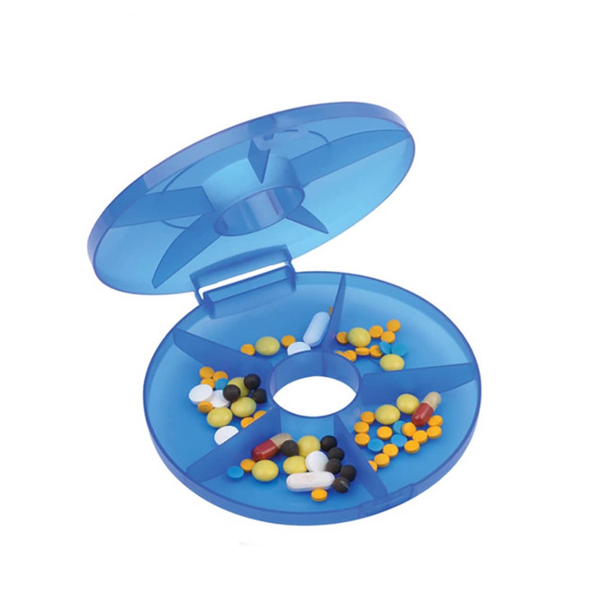 A blue pill box with multiple compartments containing various coloured pills and capsules inside.