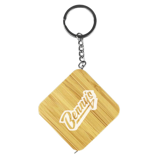 A bamboo tape measure key ring in a diamond shape with a metallic keychain attachment. Features a logo.