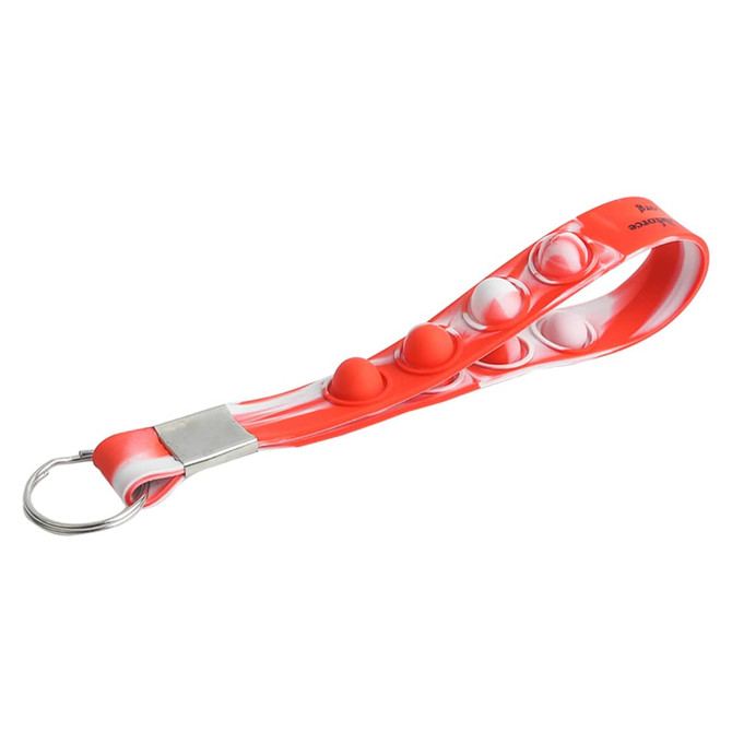 A red and white Popper Stress Reliever Keyring with multiple push buttons and a metal keyring attachment.