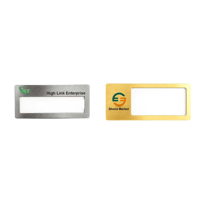 Two reusable metal name badges in silver and gold finishes, featuring a clear window for name display and logos.