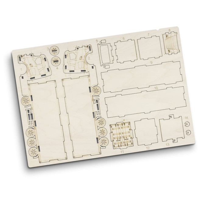 A wooden model kit featuring pre-cut pieces for constructing a large truck, displayed on a light wood board.