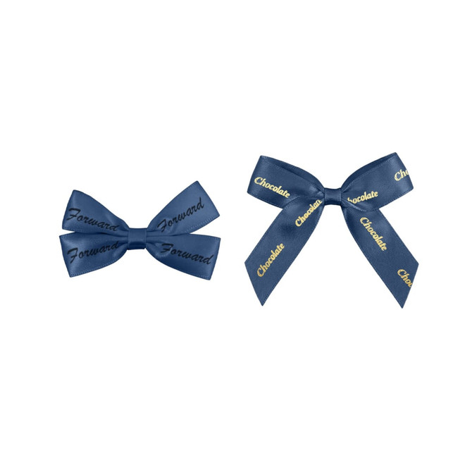 Two navy blue hair clips in bow shapes, one featuring the word "Forward" and the other with "Chocolate" printed on it.
