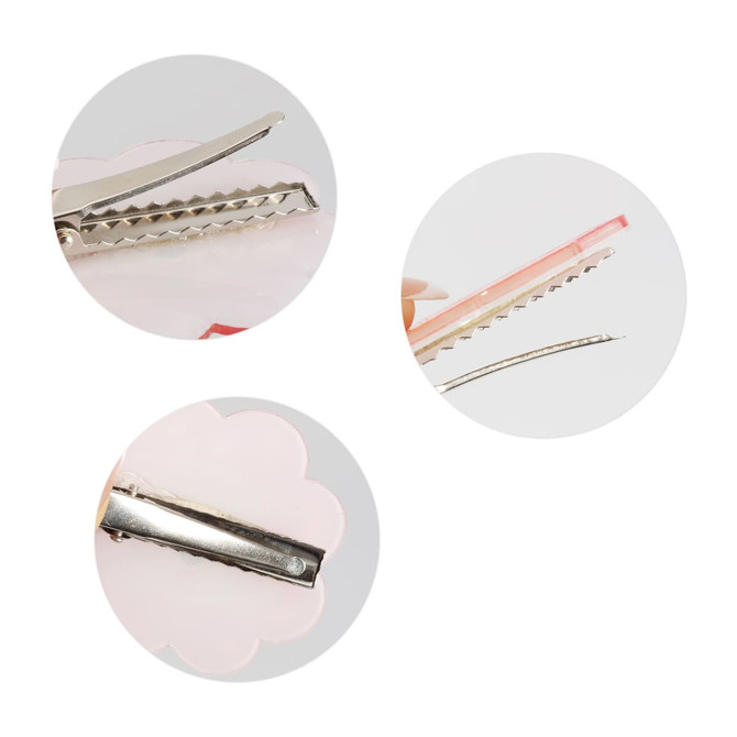 A pink custom shape acrylic hair clip with a metallic clasp, featuring a scalloped design and a logo.