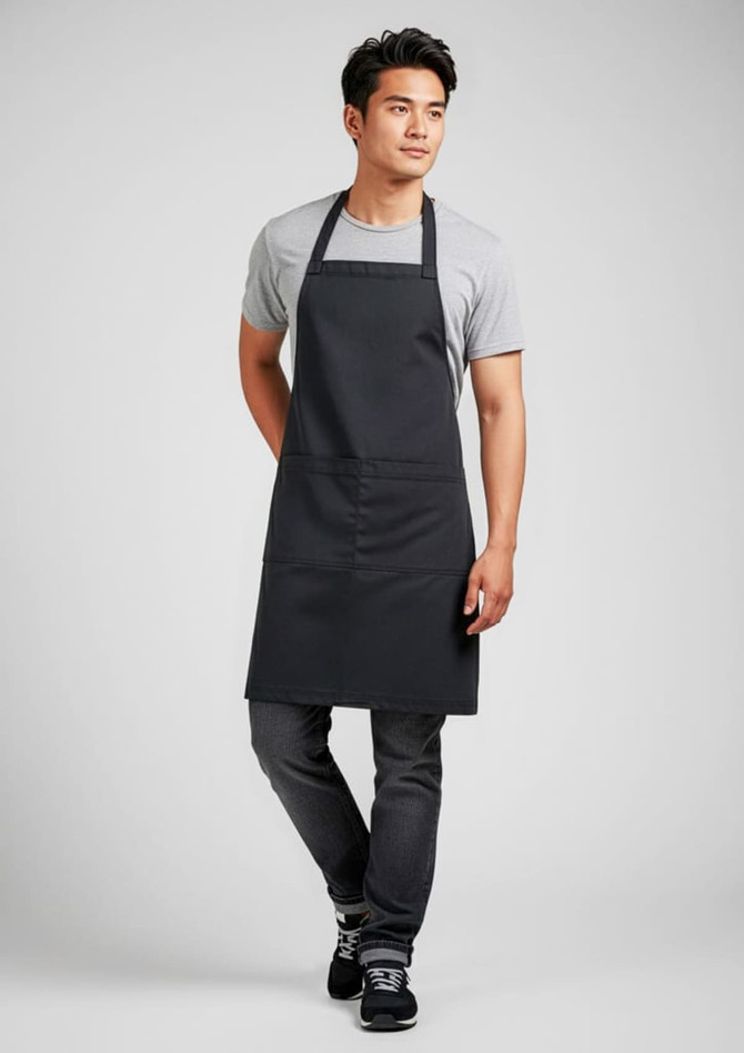 A black apron worn by a man, featuring a simple design and a front pocket, with a logo visible.
