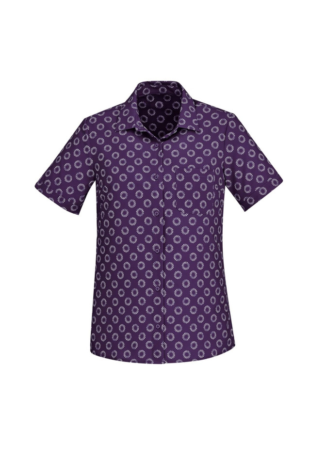 A short sleeve button-up shirt in purple featuring a daisy print pattern and a logo on the collar.