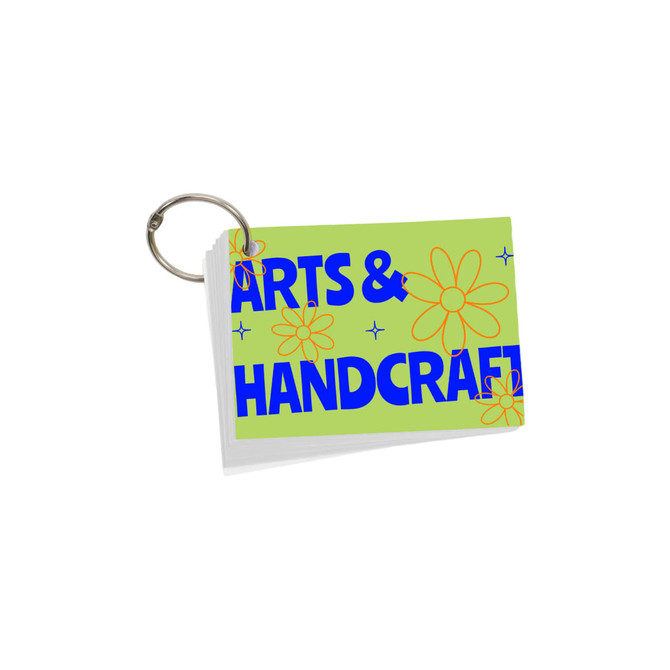 A set of A7 index cards with a ring, featuring a green background and colourful flower designs.