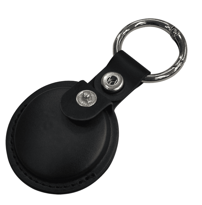 A black tracking tag with a keyring attached, featuring a leather case and metal snap.