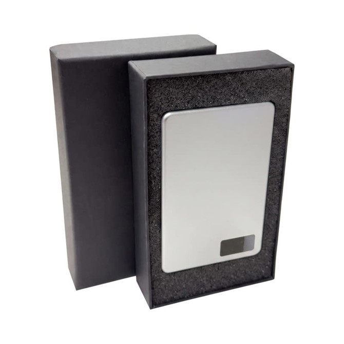 A power bank with a sleek silver finish, presented in a black packaging box.