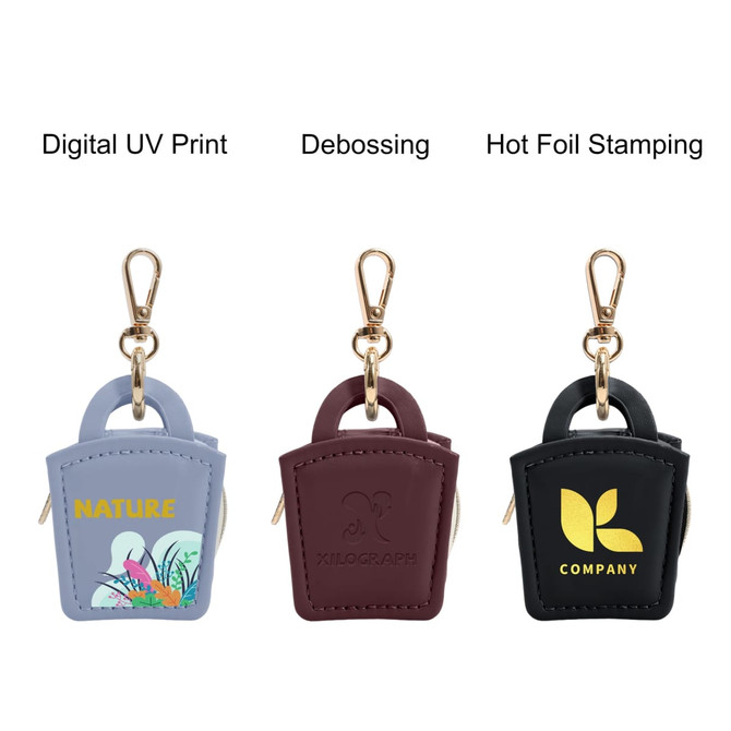 A mini PU leather jewellery box in light blue, burgundy, and black, featuring gold accents and a clip attachment.