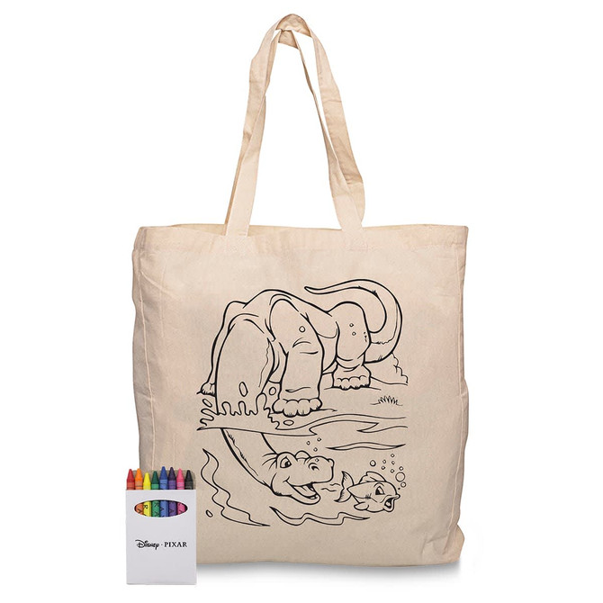 A cream calico bag with a cartoon animal design and a set of colourful crayons beside it.