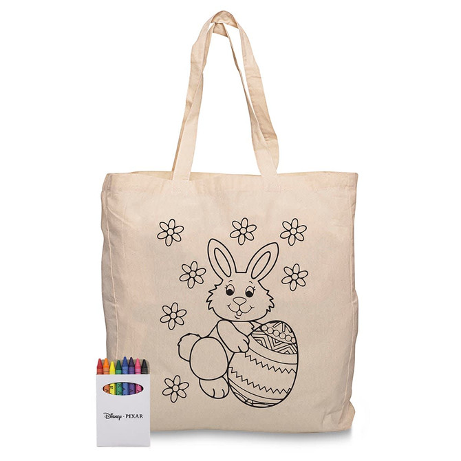 A cream calico bag featuring a colouring design of a bunny and flowers, accompanied by a set of crayons.