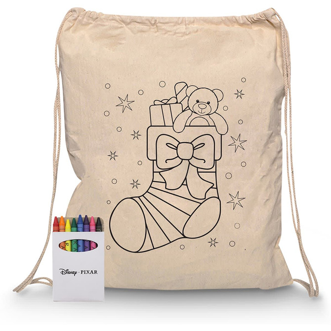 A cream drawstring bag featuring a bear and gifts design, alongside a set of colourful crayons in a box.