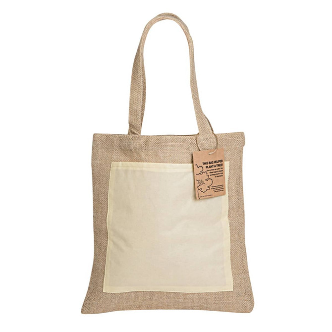 A jute tote bag in tan with a light-coloured front pocket and sturdy handles, featuring a tag and a logo.
