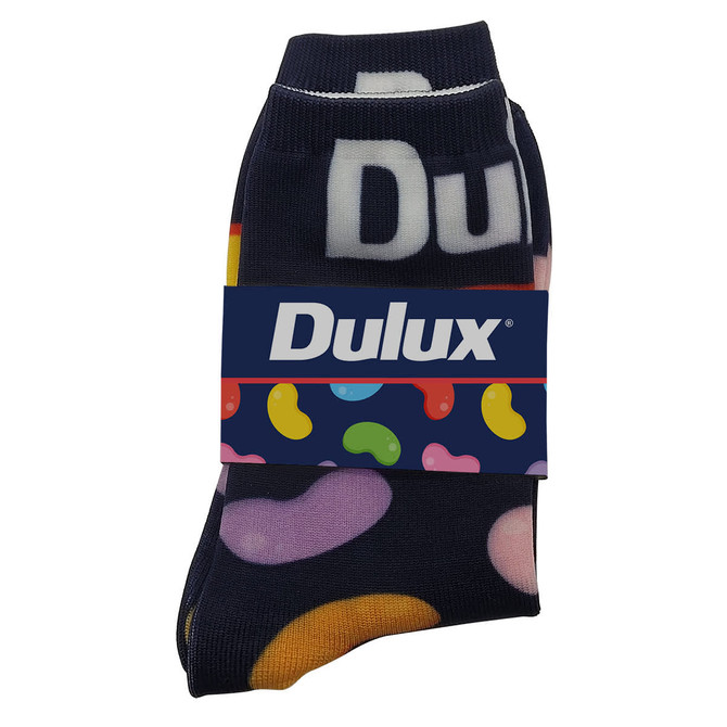 Magic Seamless Socks featuring a navy background with colourful patterns. The product includes a branded band.