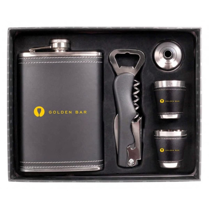 A drink bottle gift set in a black box featuring a stainless steel flask, two shot glasses, a corkscrew, and a bottle opener.