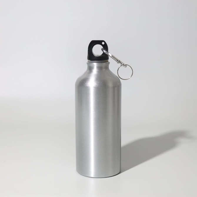 A drink bottle in silver metal with a black plastic top and a silver keyring attached.