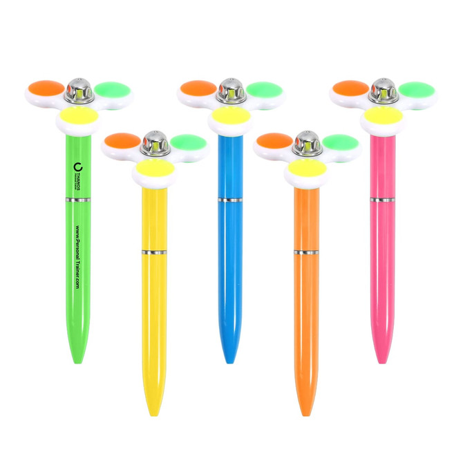 A set of five fidget pens in vibrant colours: green, orange, pink, blue, and yellow, each featuring a spinning topper.