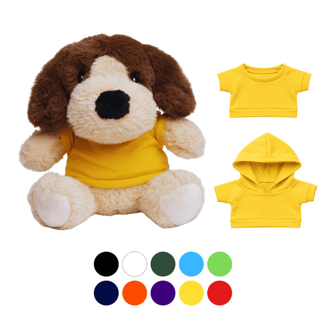 A brown and cream plush dog toy wearing a yellow T-shirt, accompanied by two additional yellow outfits.