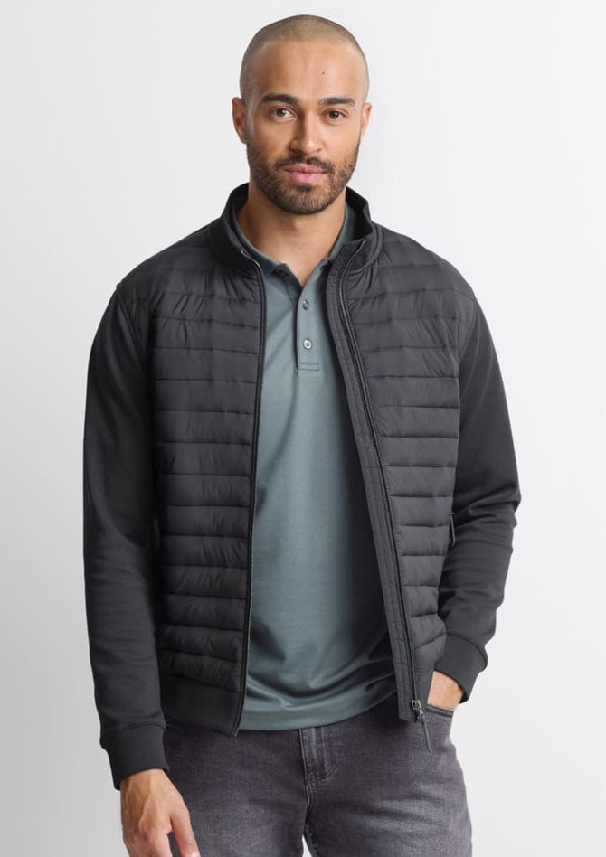 A men's tailored jacket in black, featuring a zip front and quilted detailing, worn over a green polo shirt.