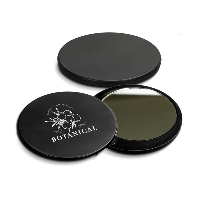 A round black compact mirror with a reflective interior and a botanical-themed design on the exterior featuring a logo.