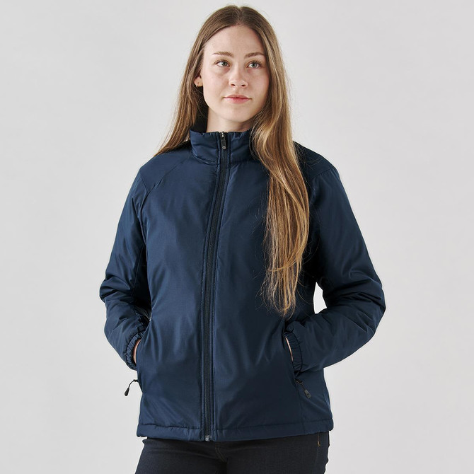 A women's thermal jacket in navy blue, featuring a zip front and side pockets, with a logo on the sleeve.