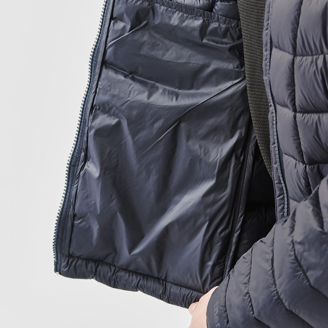 A navy blue women's puffer jacket with an unzipped interior pocket and quilted design. Features a logo on the sleeve.