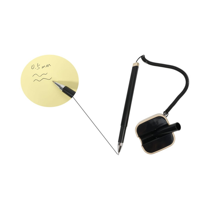 A black signature pen with a spring chain, positioned next to a yellow notepad featuring handwritten notes.
