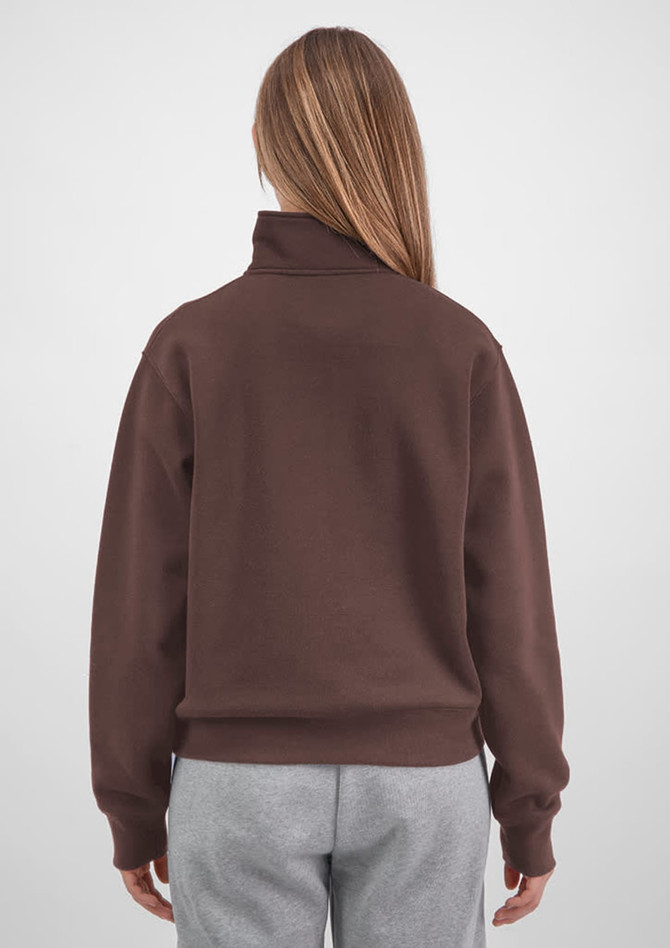 A brown 1/4 zip jumper with a relaxed fit, featuring a high collar and long sleeves. Grey pants are worn with it.