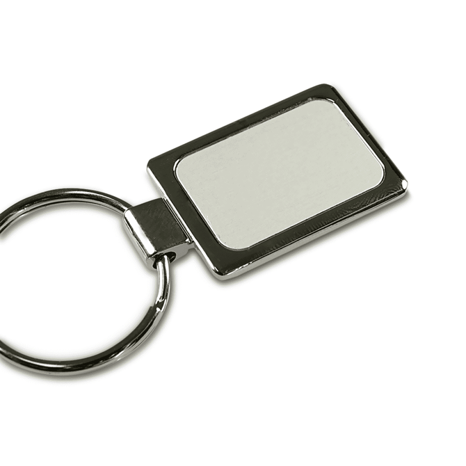 A rectangular silver keychain with a smooth surface and a metal ring attachment.