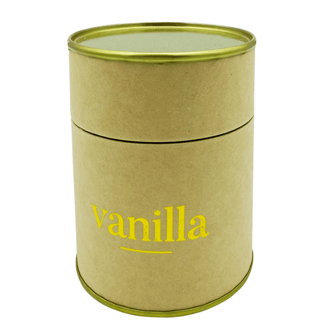 A medium Relax Candle in a round, kraft paper container with a gold lid, featuring a vanilla scent.