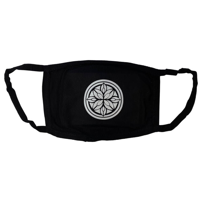 A black cotton face mask featuring a circular geometric design in the centre and ear straps for secure fitting.