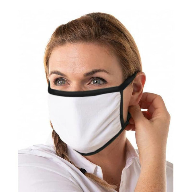 A cotton face mask in white with black trim worn by a woman, who is adjusting it.