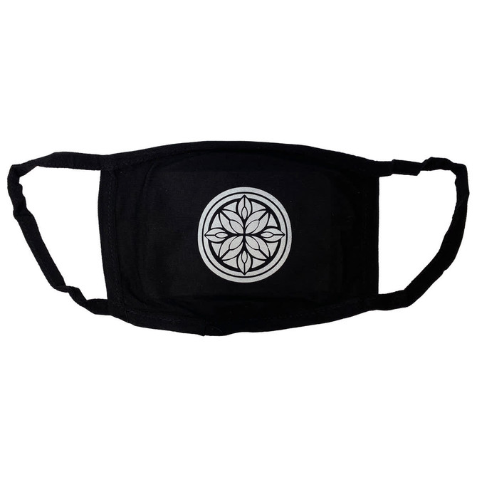 A black cotton face mask featuring a circular design in the centre and adjustable ear straps.