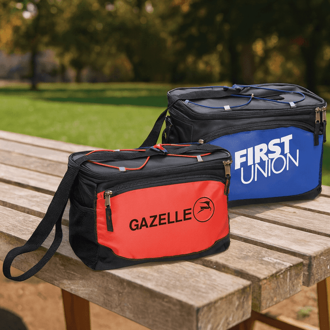 Two cooler bags in red and blue, each with a zipper and a shoulder strap, placed on a wooden table outdoors.