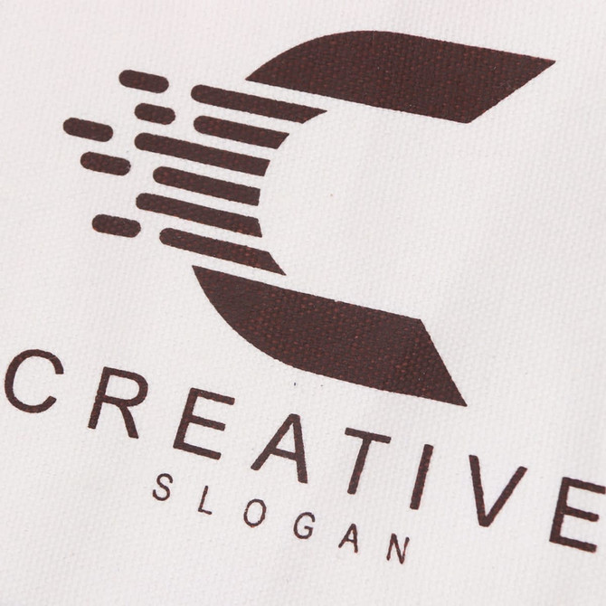 A small cream canvas tote bag featuring a brown logo with a stylised letter 'C' and the word "Creative".