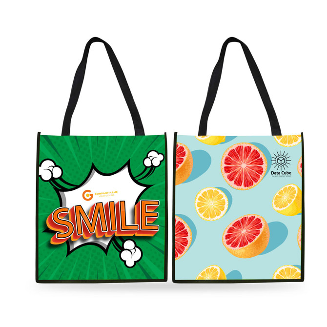 A tall non-woven tote bag featuring a bold green design with a playful "SMILE" and a fruit pattern on the reverse.