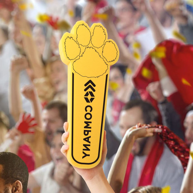 A yellow cheer stick shaped like a paw with a logo, held up in a lively crowd celebration.
