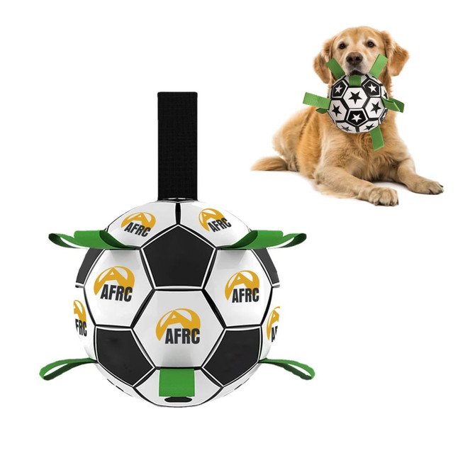 A black and white dog soccer ball with green grab tabs, accompanied by a golden retriever. The ball has a logo.
