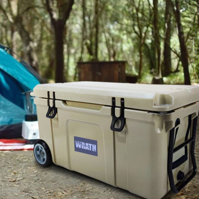 A 75L cooler box in beige with wheels, featuring handles and a logo, set in a forested camping area.