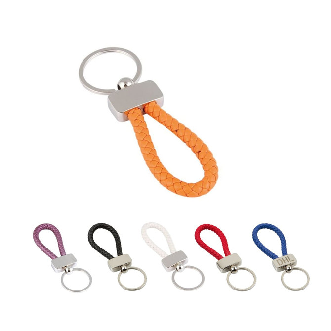 A metal keyring tag with a braided strap in orange, surrounded by keyring tags in purple, black, white, red, and blue.