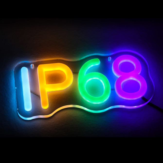 A vibrant Neon LED sign featuring the colours yellow, green, and purple, with an IP68 designation, and a logo.