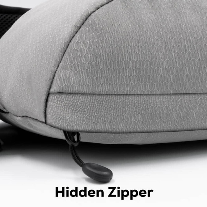A grey Sling Eco Bag featuring a textured surface and a hidden zipper detail. Includes a logo on the side.