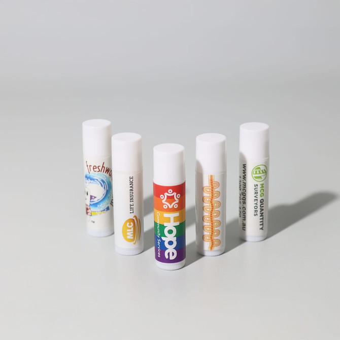 A selection of five lip balm tubes in various designs and colours, all featuring white caps and different labels.