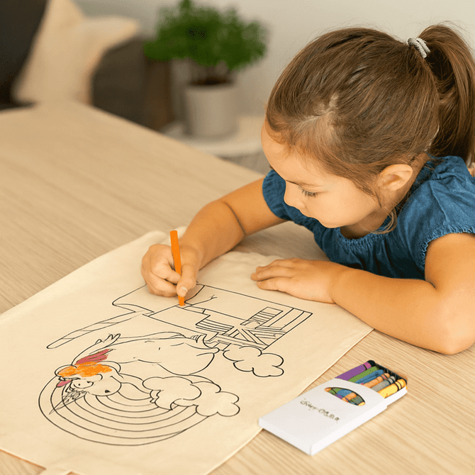 A girl colours a rainbow design on a beige sheet, with a crayon set next to her. The scene features bright, playful art.
