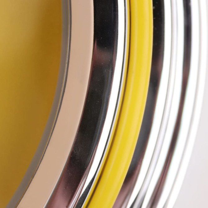A close-up of a double ring wall clock with yellow, silver, and chrome accents. The design features a glossy finish.