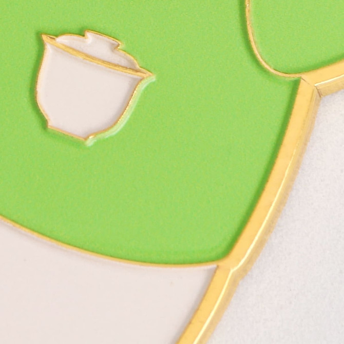 A drink bottle opener in a custom shape, featuring green and white colours, with gold edging and a logo.