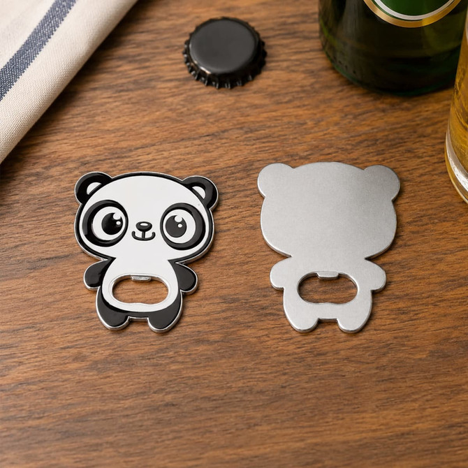 A drink bottle opener in the shape of a panda, featuring a black and white design, on a wooden surface.
